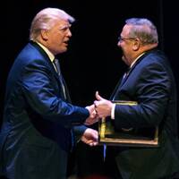 Trump greets LePage at a rally. LePage later advocated "authoritarian power."