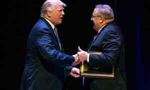 Trump greets LePage at a rally. LePage later advocated "authoritarian power."