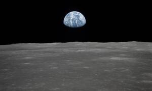 AS11-44-6552 (16-24 July 1969) --- This view of Earth rising over the moon's horizon was taken from the Apollo spacecraft. The lunar terrain pictured is in the area of Smyth's Sea on the nearside. Coordinates of the center of the terrain are 85 degrees east longitude and 3 degrees north latitude. While astronaut Neil A. Armstrong, commander; and Edwin E. Aldrin Jr., lunar module pilot, descended in the Lunar Module (LM) "Eagle" to explore the Sea of Tranquility region of the moon, astronaut Michael Collins remained with the Command and Service Modules (CSM) "Columbia" in lunar orbit.